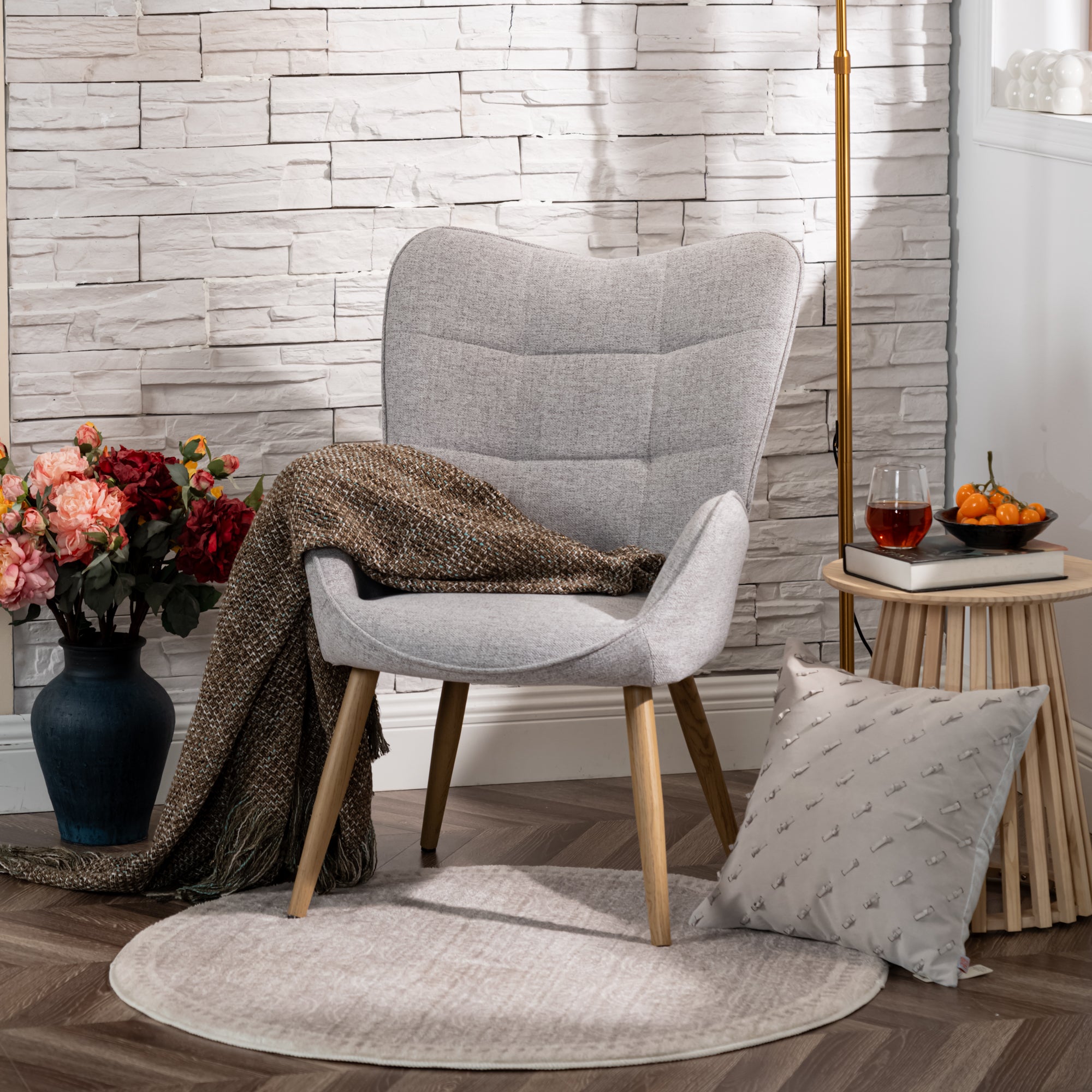 Scandinavian armchair with armrests in gray fabric with stitching