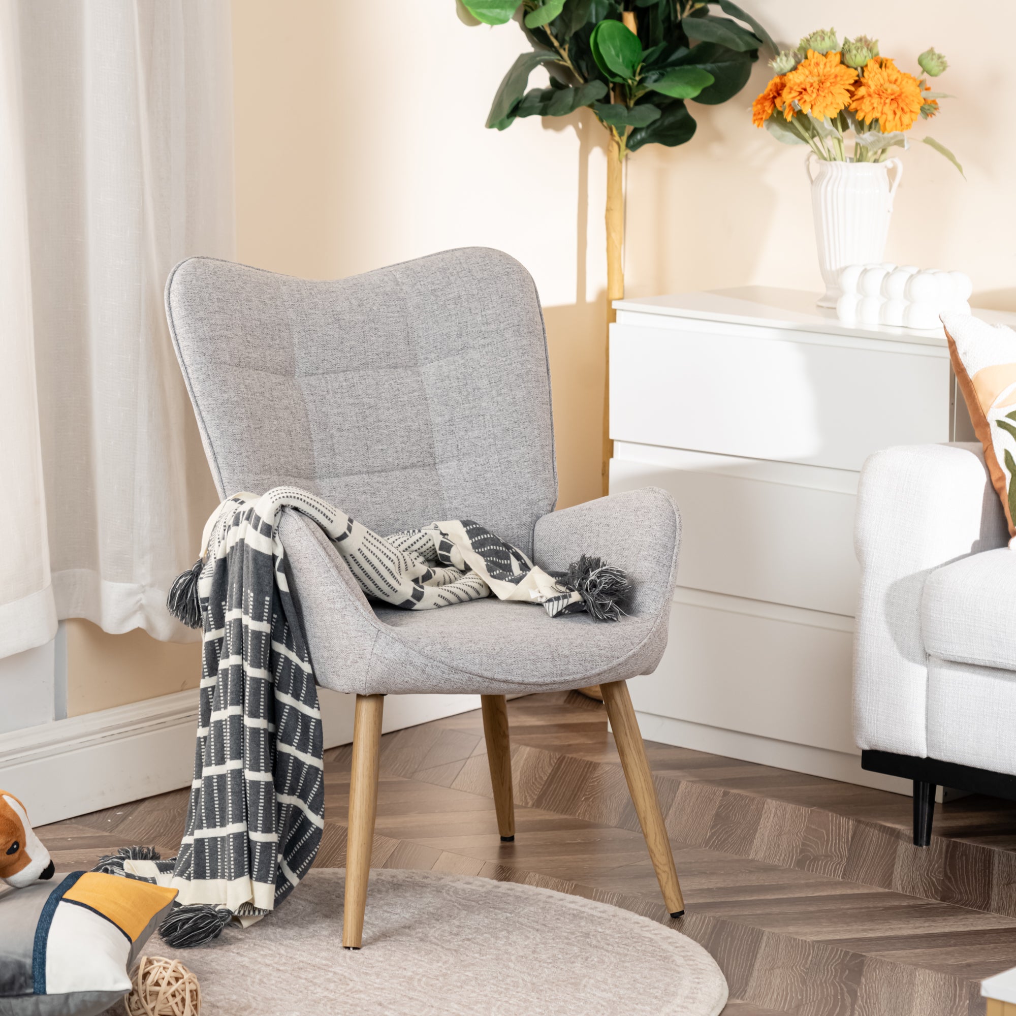 Scandinavian armchair with armrests in gray fabric with stitching